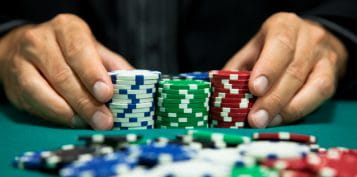 Poker Player Pushing His Chips Forward