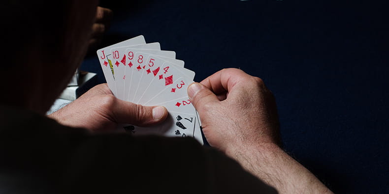 Man Holding a Lots of Cards