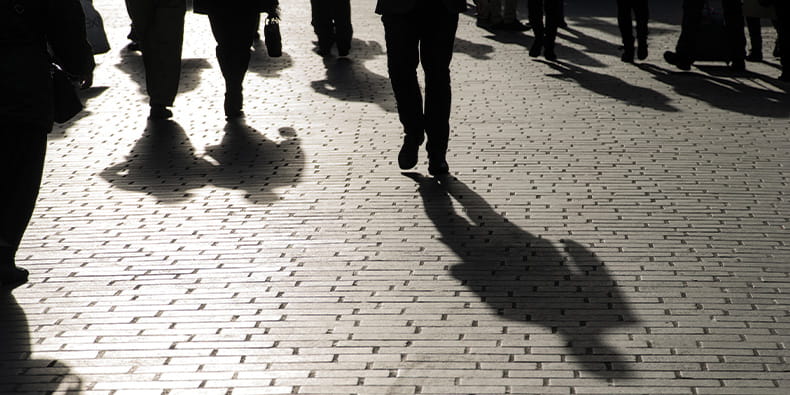 Men Walking On The Sidewalk In The Evening