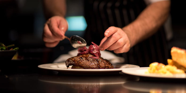 Chef decorating fine gourmet meals for its customers