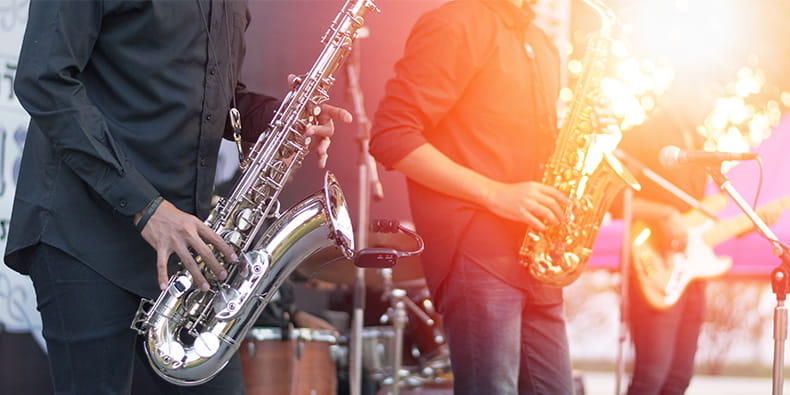 Three musicians playing on a stage