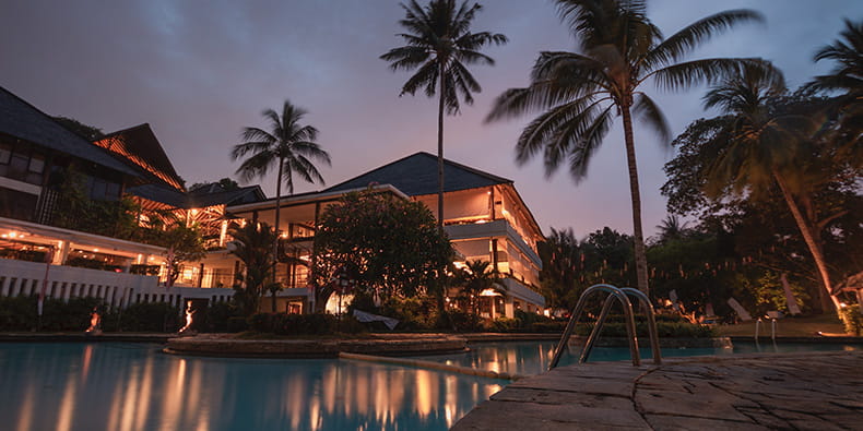 Stunning view of the resort's outdoor pool and palm